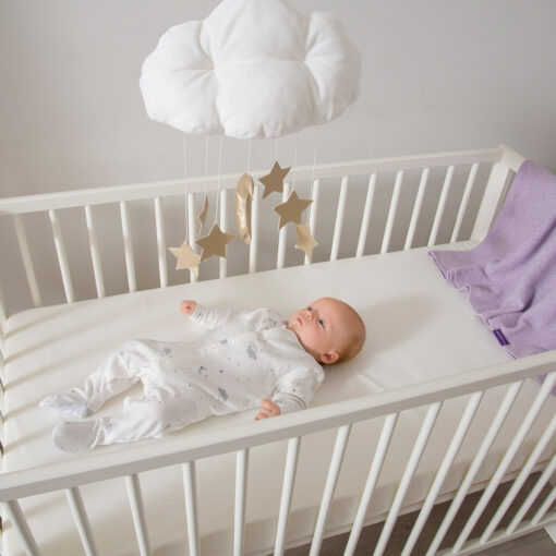 baby on waterproof support baby mattress in cot bed
