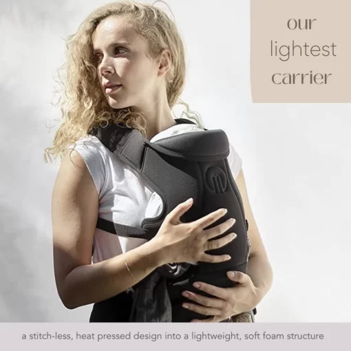 mother holding newborn in hipster essential baby carrier