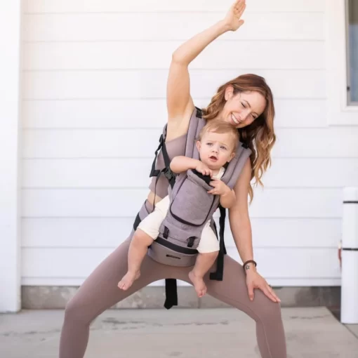 mother doing yoga while carrying baby in miamily hipster plus baby carrier