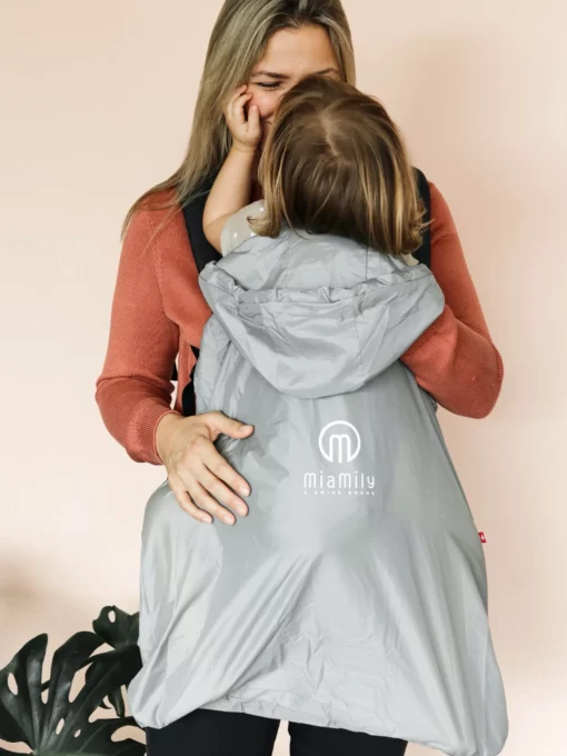 Mother carrying baby in baby carrier with MiaMily Summer cover